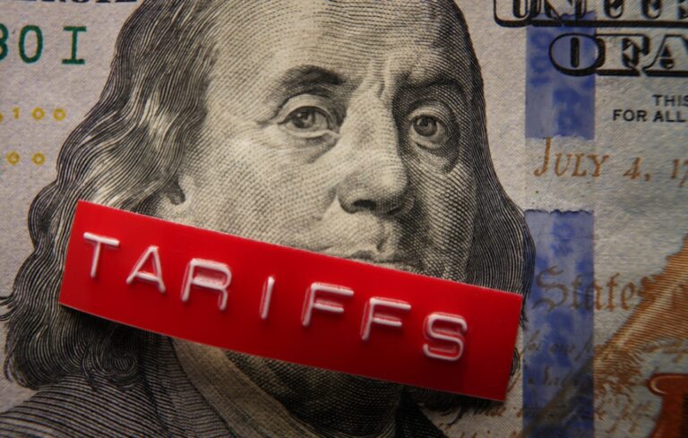 Red Tariffs label on a hundred dollar bill