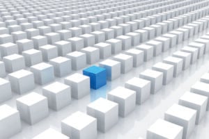 One blue cube stands out amid rows of white cubes