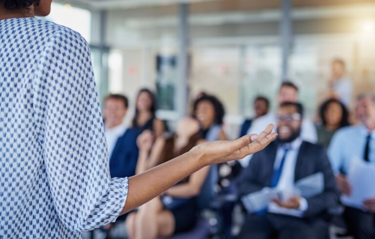 Female leader speaking to employees.