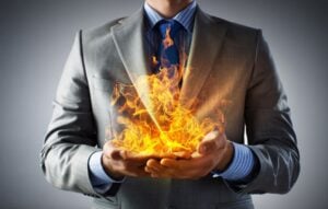 Business man holding flame
